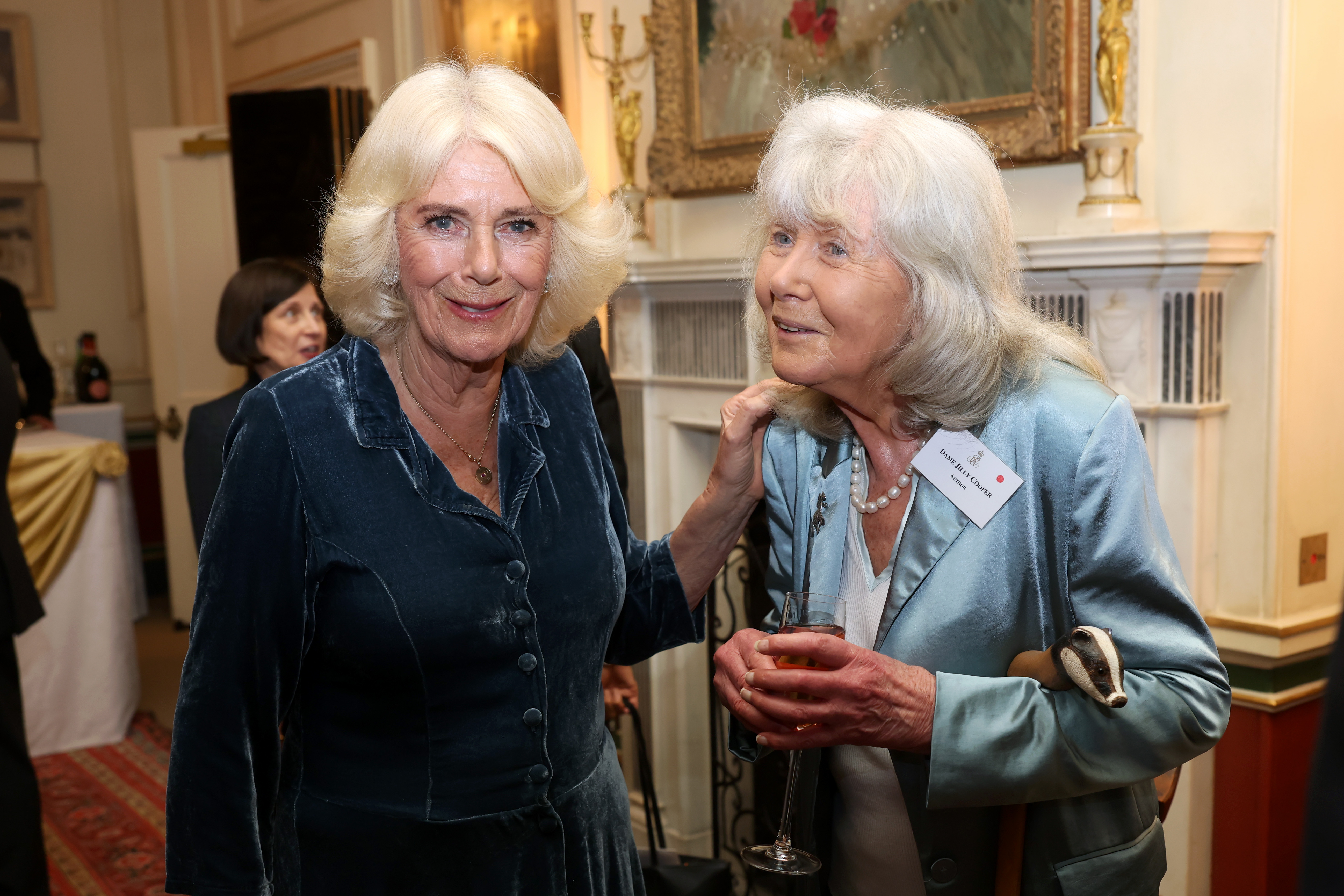 Queen Camilla and Jilly Cooper pose during a reception to mark the launch of the Queen's Reading Room. medal.