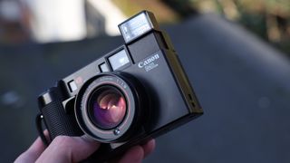 Canon AF35ML film camera held in a hand