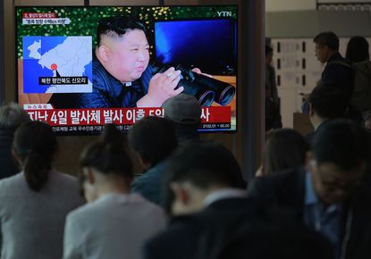 South Koreans watch news about North Korean missile launch