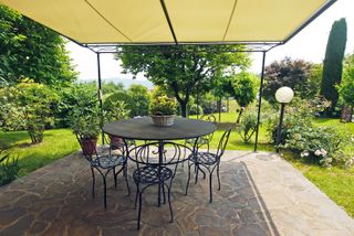 awning ideas: large neutral awning over patio with supports