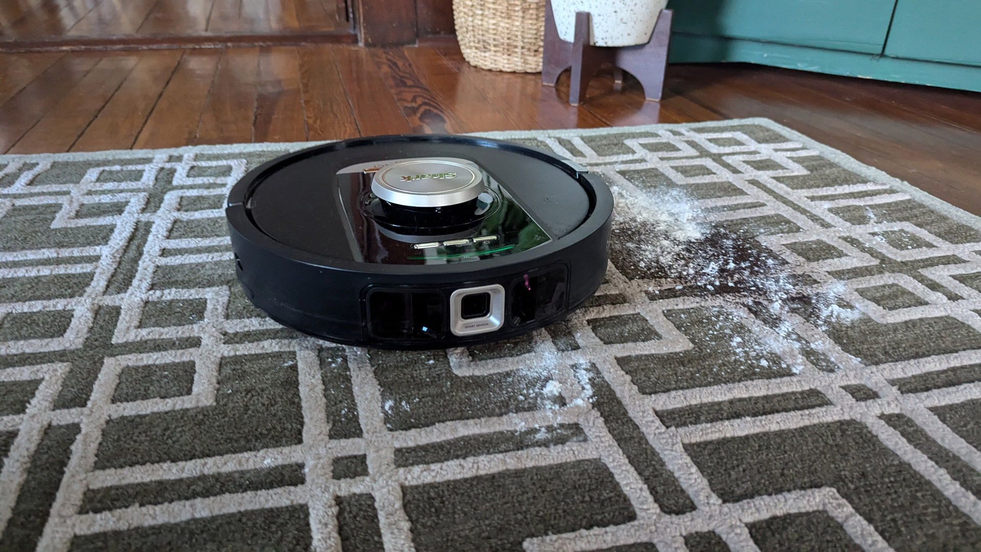 The Shark PowerDetect Robot Vacuum and Mop cleaning up flour and coffee