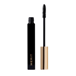 An opened black Merit mascara tube with a gold wand cap and lettering.