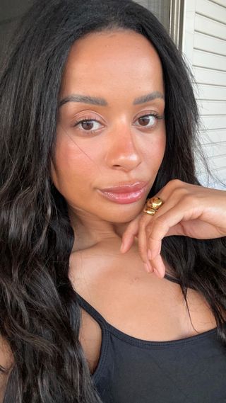 Esthetician and skincare educator @katieo.skin poses for a selfie with freshly moisturised skin.