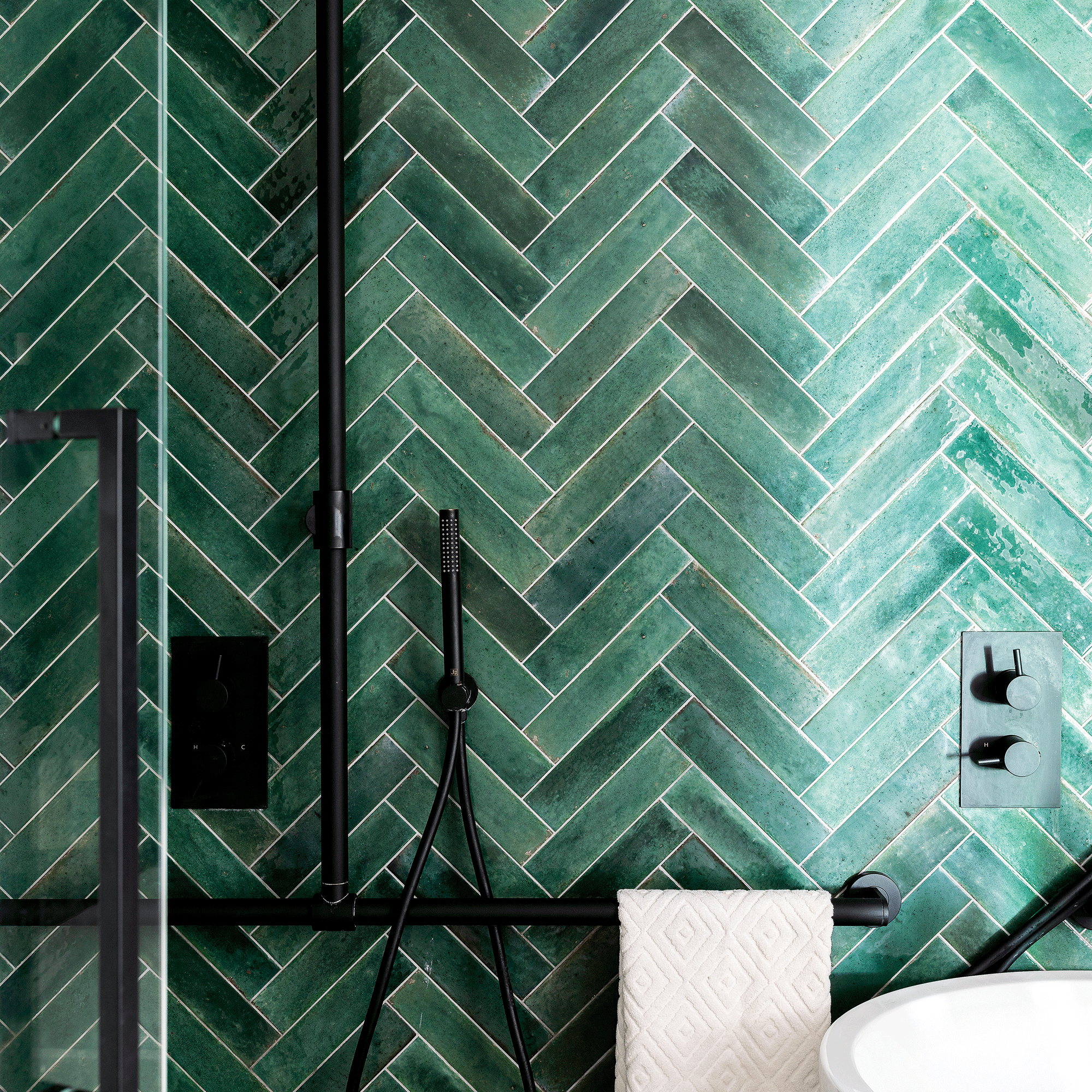 Green tiles in a herringbone layout