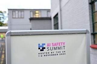 AI Safety Summit advertisement pictured on a board at Bletchley Park, UK. 