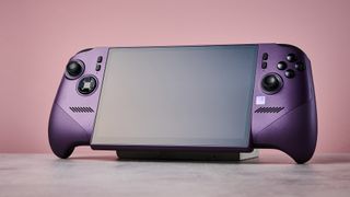 The MSI Claw 8 EX AI+ with its screen off in front of a pink background.
