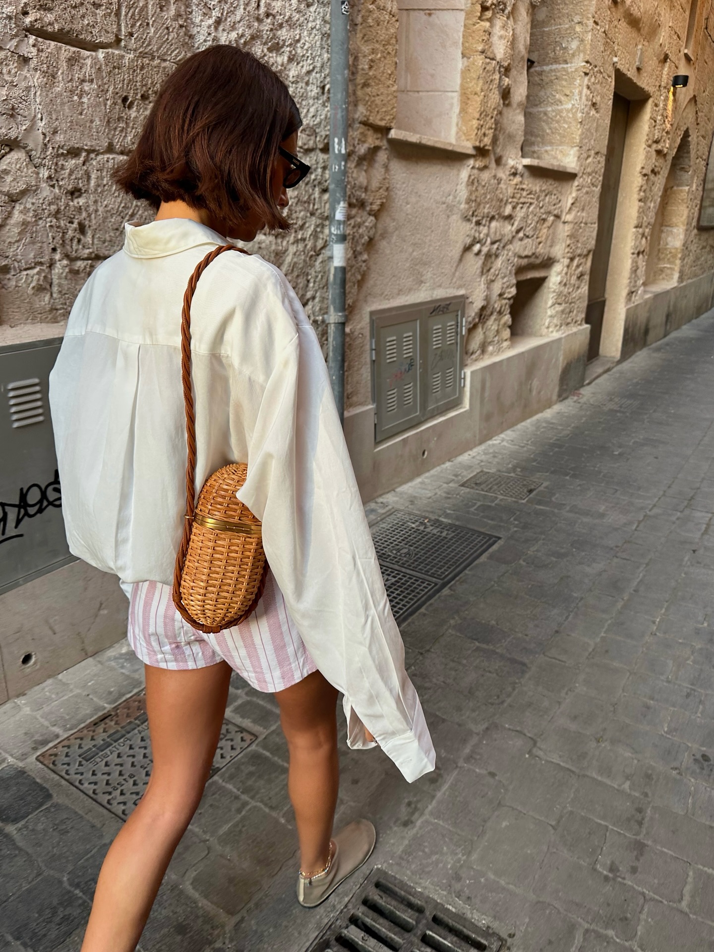An image of @smythsisters wearing an oversized shirt.