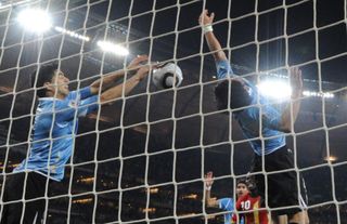 Uruguay's Luis Suarez stops a goal with his hands against Ghana at the 2010 World Cup.