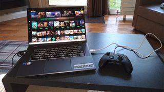 Acer Chromebook 516 GE review; a gaming laptop on a coffee table with an Xbox controller