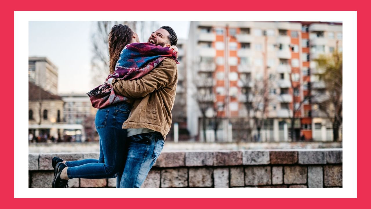 couple hugging and laughing on the city streets