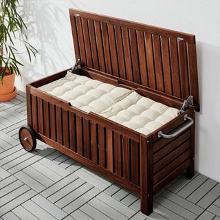 Mobile wooden storage bench with stainless steel handle and 2 wheels with outdoor cushions inside