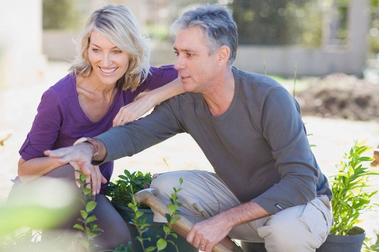 Two People Sitting In The Garden