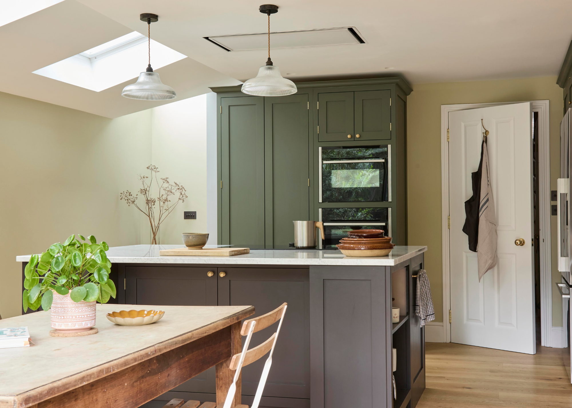 earthy toned tri color kitchen with a dark grey island