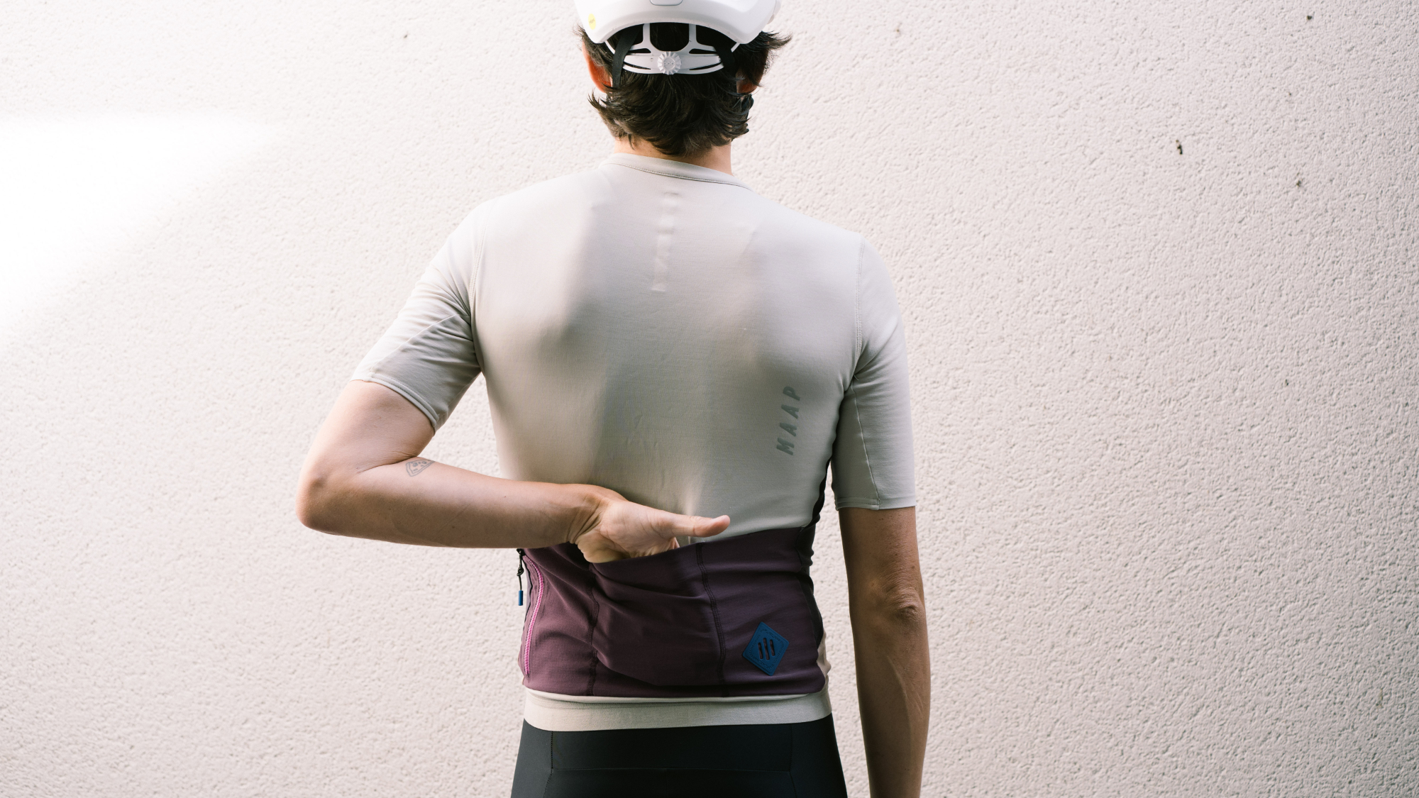 Maap Alt_Road jersey worn by a man against a white wall