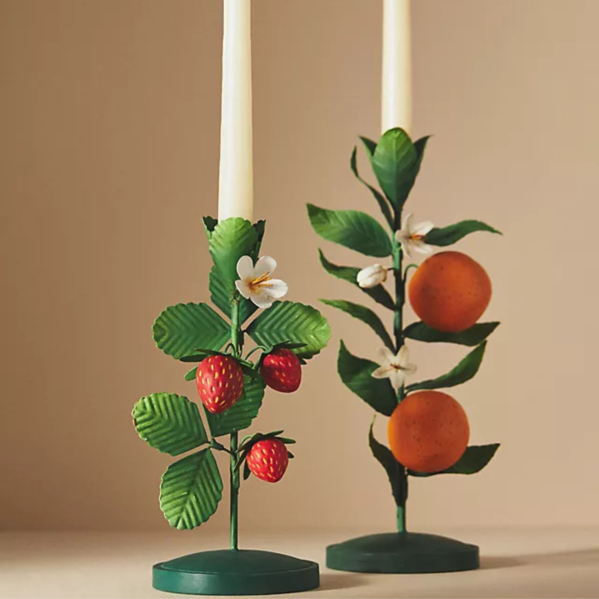 green metal candlesticks with strawberries and oranges