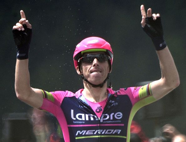 Rui Costa raises his arms as he crosses the line