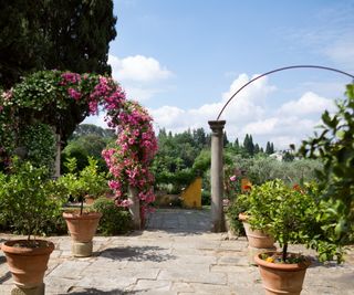 Tuscan garden with aged stonework and pots