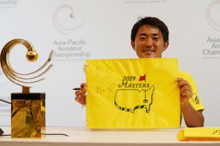 Takumi Kanaya holds up a Masters pin flag after winning the 2018 Asia-Pacific Amateur Championship