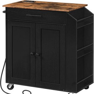 black kitchen island on wheels with wooden countertop and power outlet