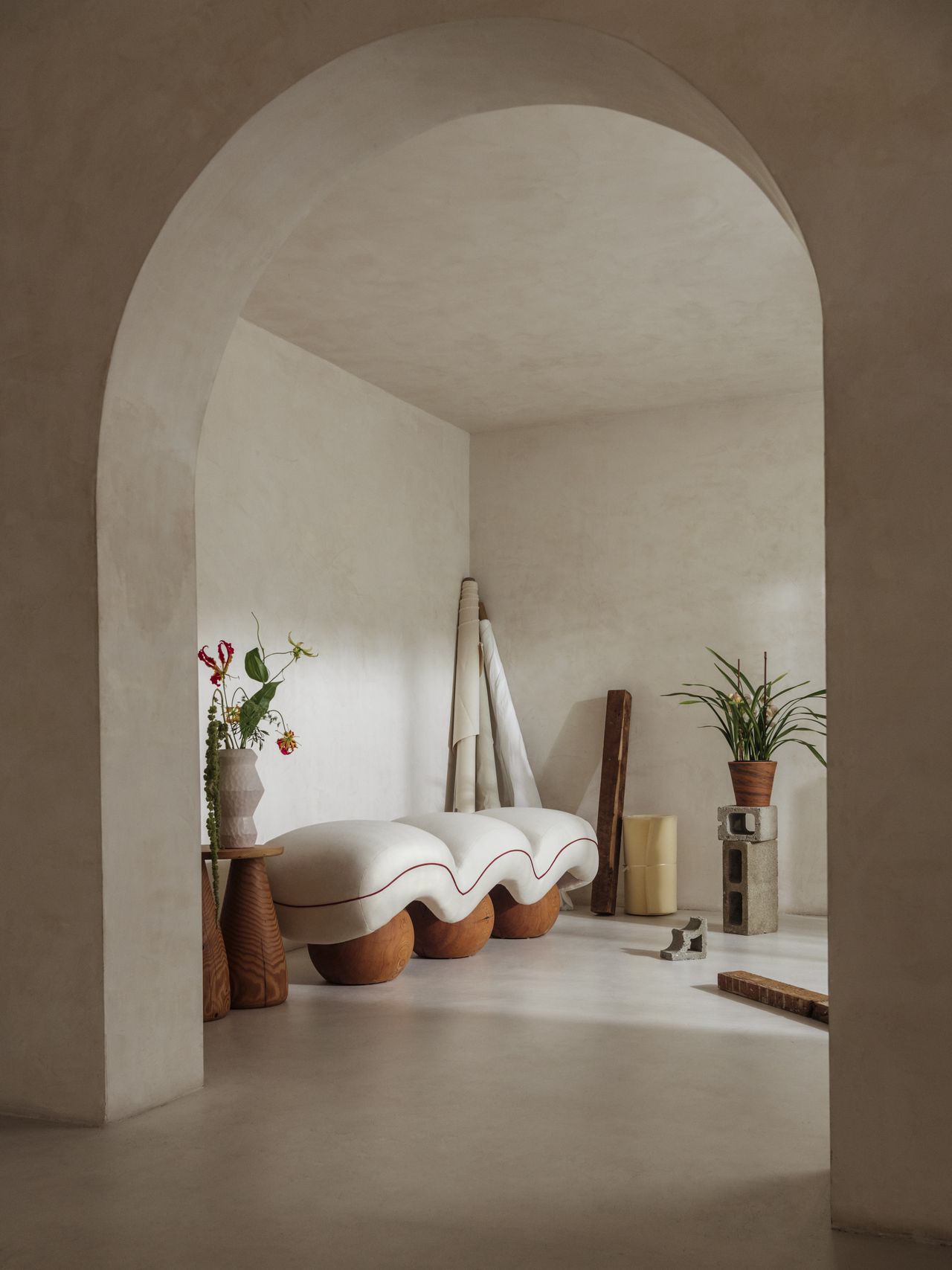 Chunky-looking furniture items including armchairs, chairs, stools, coffee tables, and sofas boast an organic feel and pleasing surface against a cream background.