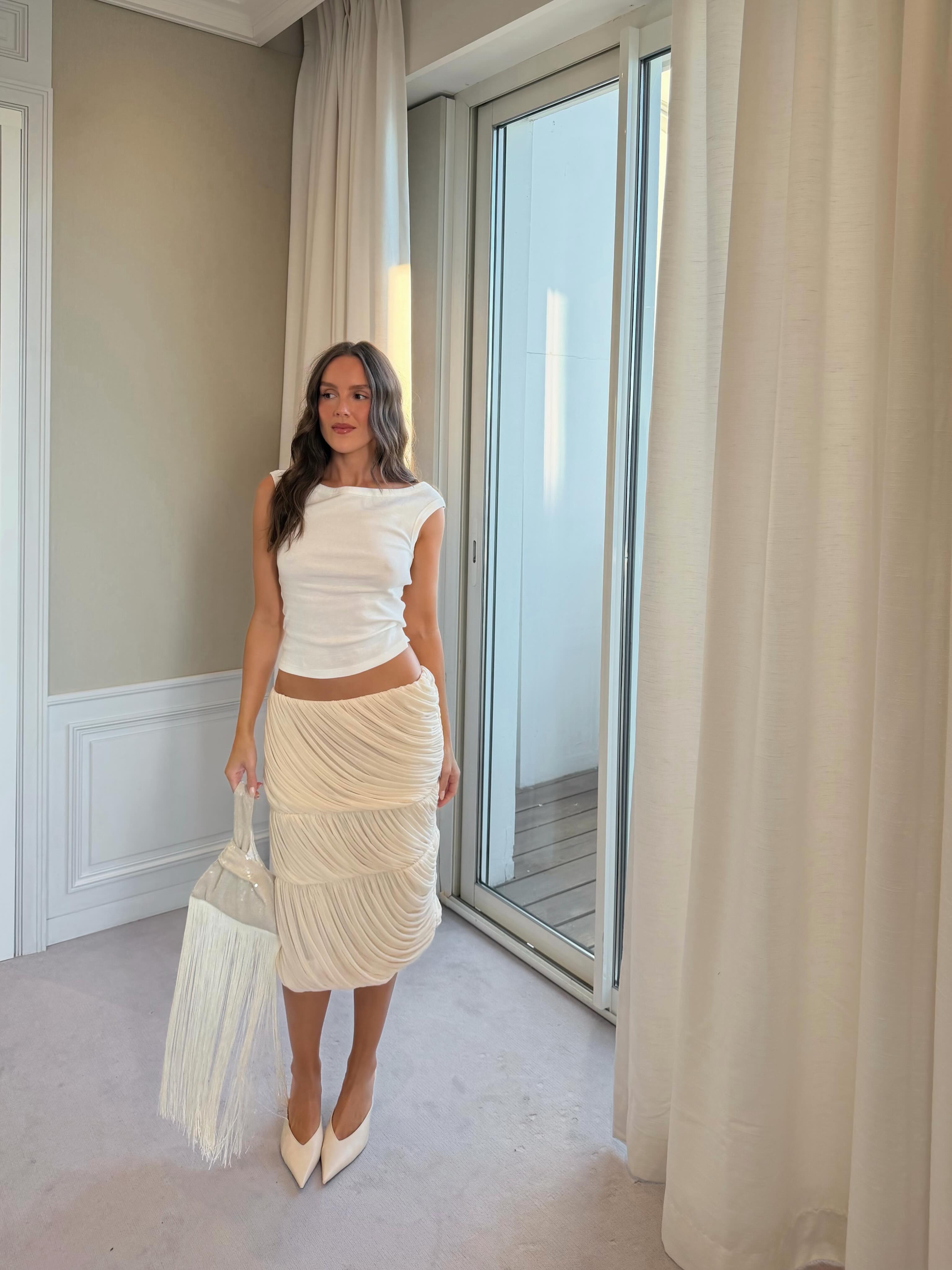 An image of a woman wearing best off white skirt for summer