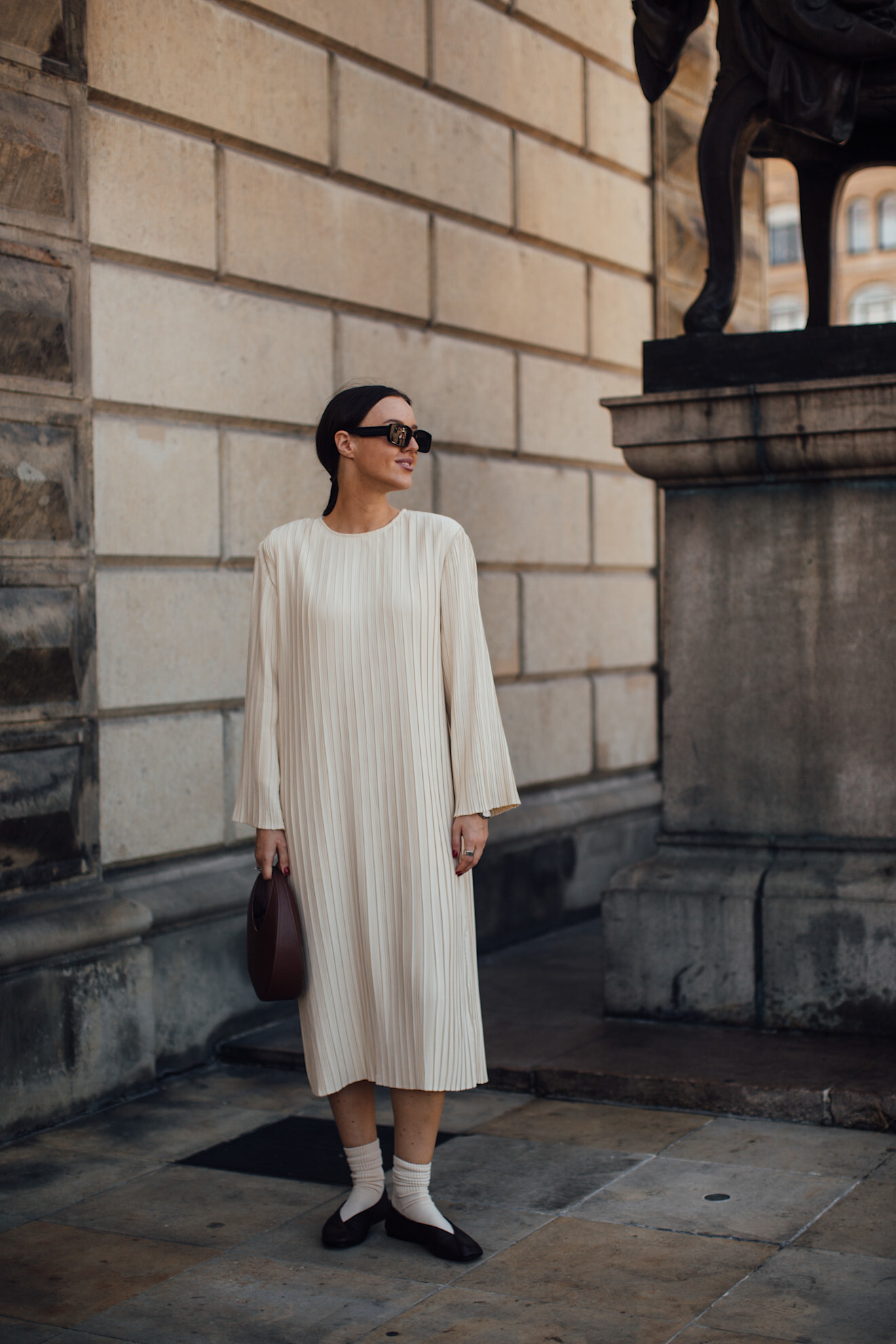 woman wearing white dress, socks, and black ballet flats