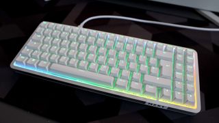 NZXT Function Elite MiniTKL with RGB lighting enabled on a desk.