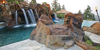 swimming pool in American backyard with waterfalls