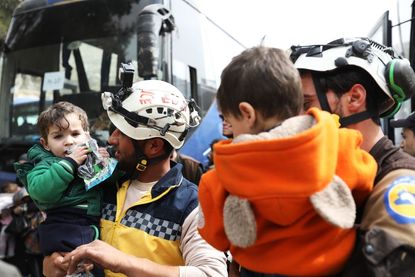 White Helmet volunteers evacuate children in Syria