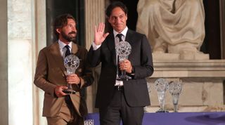 Former Italy players Andrea Pirlo and Alessandro Nesta hold trophies at the FIGC Hall of Fame event on 23 May, 2022 in Florence, Italy.