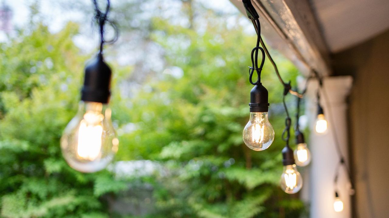 Solar lights on a porch in front of a garden 