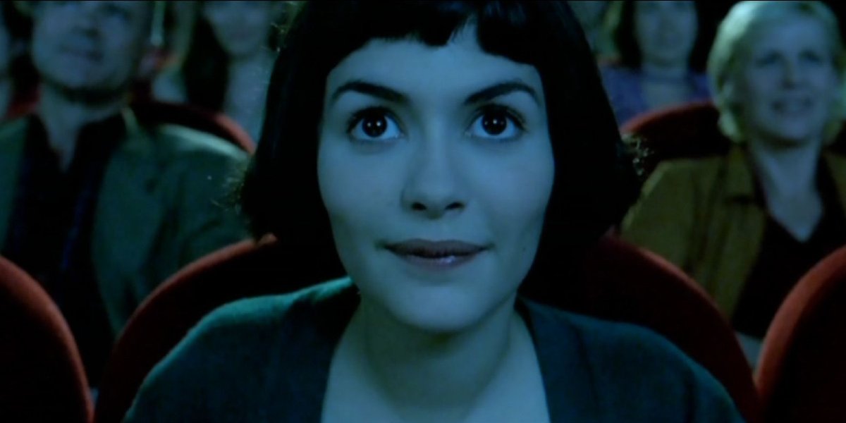 Amelie Audrey Tautou bathed in the glow of a movie screen