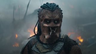 Screenshot from Predator Badlands showing the Predator, an humanoid alien creature with four mandibles and dreadlocks.