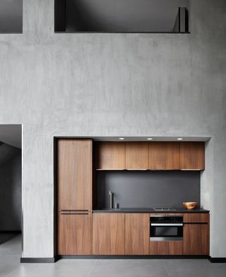 grey kitchen with wooden cabinets in the Poliform Penthouse design in Gansevoort Meatpacking Manhattan hotel in New York