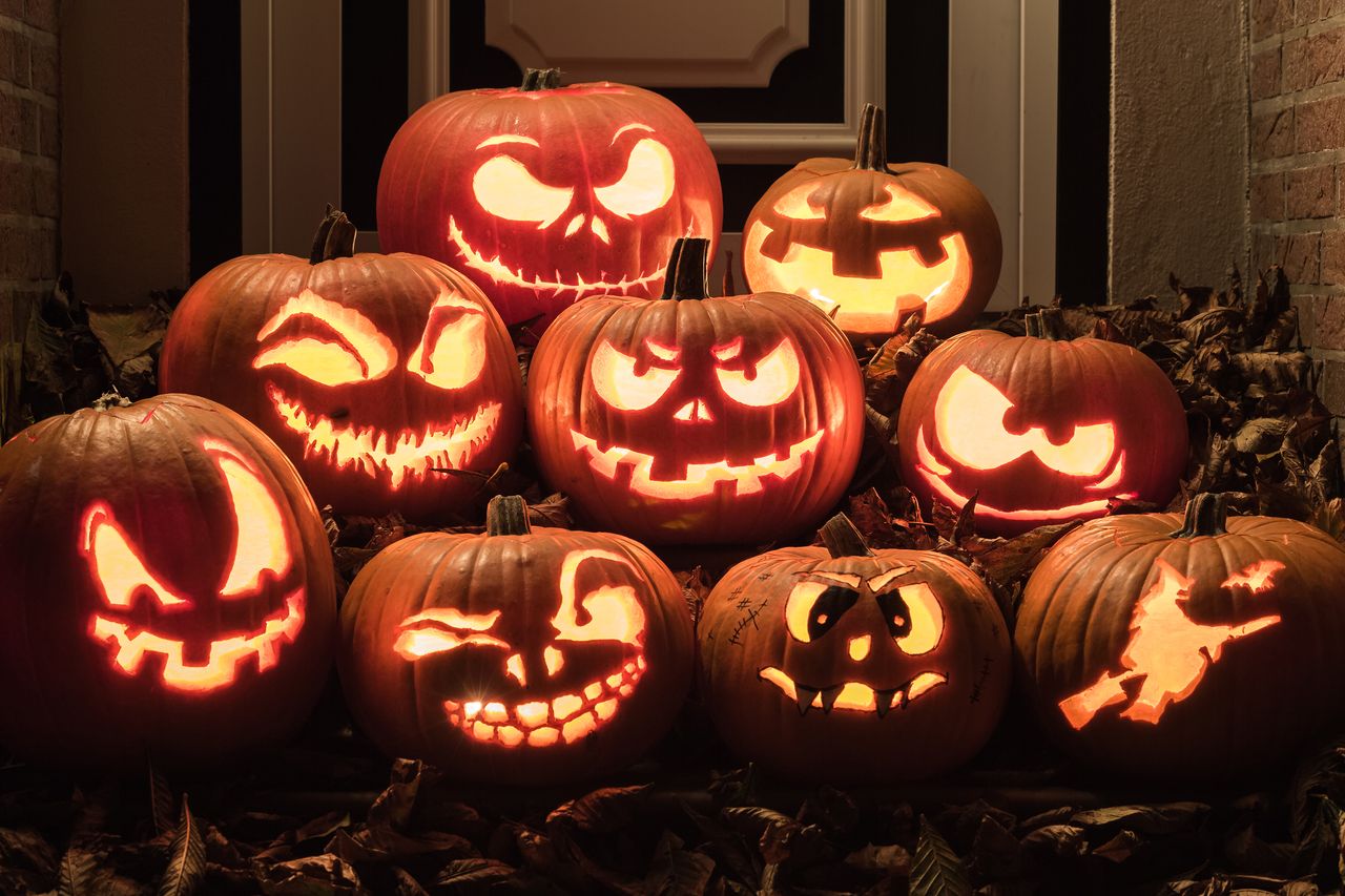 A pile of carved glowing pumpkins