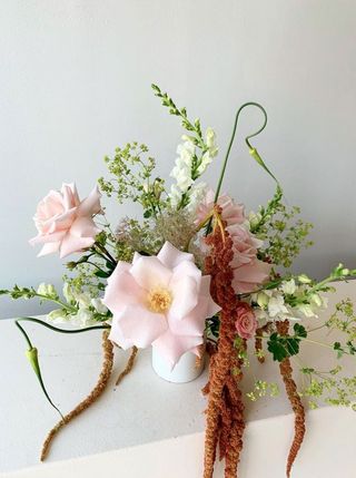 Bouquet by Miami florist Calma featuring big light pink flowers surrounding by smaller pink and white flowers