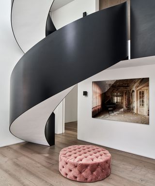 Modern entryway with black painted spiral staircase