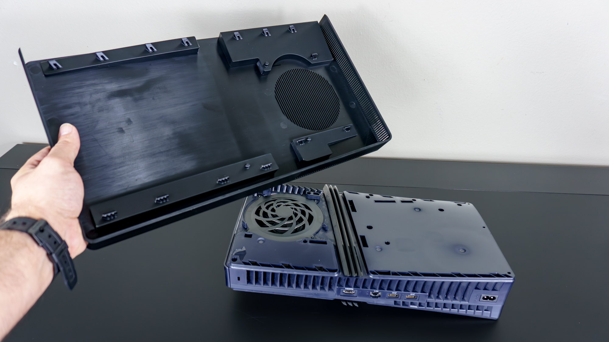 A person installing a set of BoxPlates console covers on a PS5 Pro
