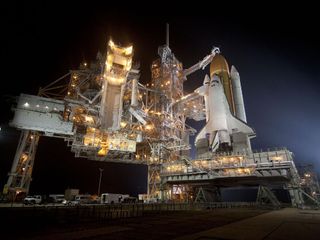 At Nasa's Kennedy Space Center in Florida, space shuttle Discovery is seen shortly after the rotating service structure was rolled back at Launch Pad 39A.