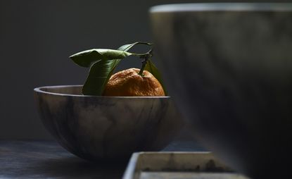 Rotten orange in a bowl