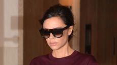 Victoria Beckham wearing burgundy top with grey suit trousers in New York City in 2017