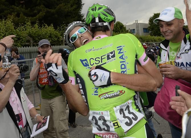 Canola is congratulated by a teammate