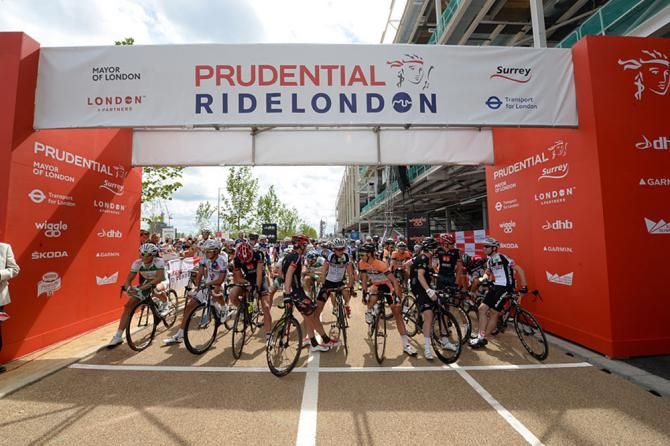 The riders line up to the start of the race in the Olympic park.