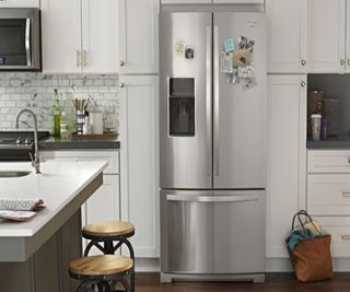 A kitchen with a double door stainless steel fridge