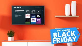 onn. 50-inch smart tv mounted on orange wall with black friday deal tag