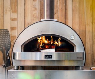 stainless-steel pizza oven on a table