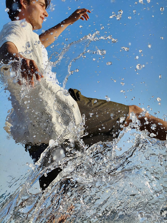 An individual splashing through water