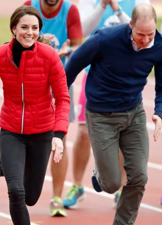 Prince William and Kate Middleton racing on a running track