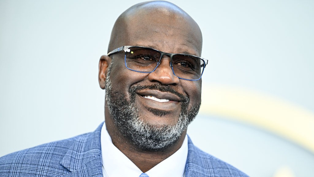 NBA basketball star Shaquille O'Neal in a blue blazer and tie, wearing sunglasses
