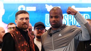 Oleksandr Usyk and Daniel Dubois pose for a photo after facing off during a press conference ahead of the Undisputed IBF, IBO, WBC and WBO World Heavyweight Titles' fight